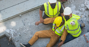 Two construction workers quickly react to an injured co-worker, using the tools they learned in a BLS certification course.