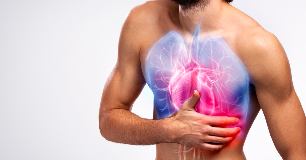 A shirtless man stands with his hand over his heart. There is an illustration of the lungs and heart on his chest.